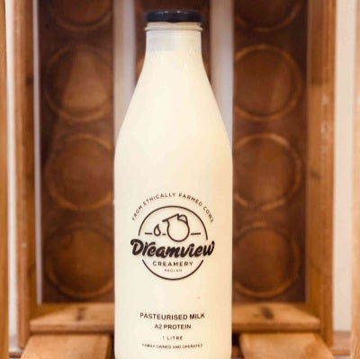 White milk bottle with 'Dreamview Creamery' logo against a wooden background