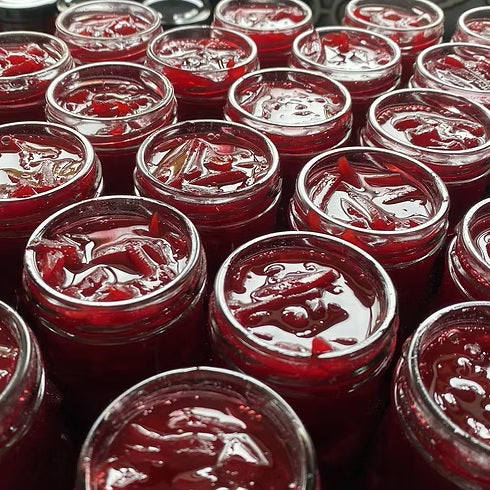 Multiple open jars of Foraged in Raglan's beetroot relish full of preserving ready for lids.